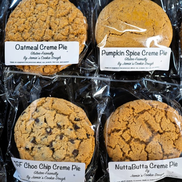 Four individually wrapped vegan creme pies: Oatmeal, Pumpkin Spice, Chocolate Chip, and NuttaButta.